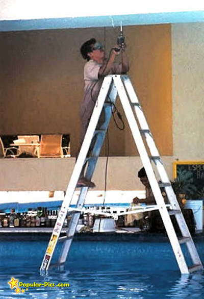 man%20working%20on%20electricity%20on%20ladder%20in%20water.jpg